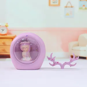 Detail shot of purple fairy night light ornament with matching antler branch stand for bedroom decor.