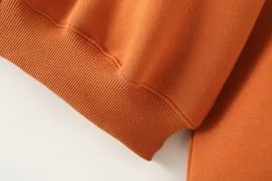 Orange sweatshirt cuff detail, premium ribbed knit fabric texture close up view shot.