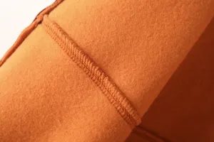 Orange fleece fabric detail of women casual bomber jacket and sweatshirt clothing set.