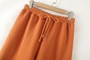 Orange casual pants elastic waist drawstring detail close up view comfortable loungewear