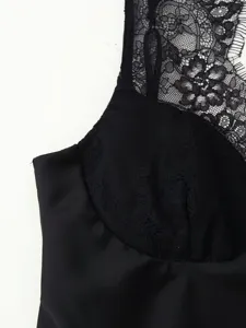 Close-up detail of black floral lace and satin camisole top, elegant sleeveless design texture.