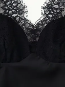 Close-up detail of women black lace satin camisole top V-neck floral lace texture elegant.