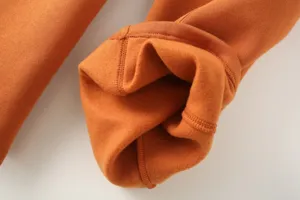 Close-up detail shot of winter warm thick fleece-lined pants cuff with neat stitching.