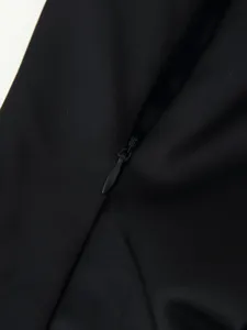 Close-up detail showcasing the concealed zipper and smooth black fabric texture clearly.