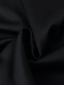 Black satin fabric detail close-up showing smooth texture, fine weave, and elegant folds.