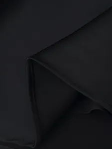 Black satin fabric detail shot, smooth texture, fine stitching, elegant garment texture closeup.