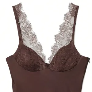 Close-up detail of dark brown satin camisole with delicate lace trim neckline and straps.