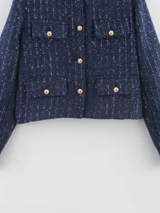 Detailed product view of women navy blue tweed jacket with gold buttons and pockets.