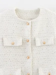 Detailed close-up of chic women's tweed jacket featuring round neckline, gold buttons, and pocket design.