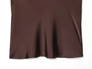Dark brown satin fabric detail, smooth texture, elegant women top hem close up design