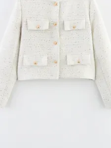 Close-up of women's short tweed jacket featuring elegant gold buttons and four pocket details.