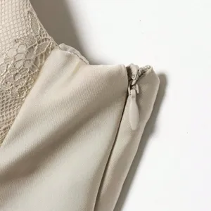 Detail view of women's sleeveless lace satin texture top featuring side zipper craftsmanship.