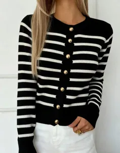 Detailopname van het zwart-wit gestreepte dames gebreide vest met elegante gouden knopen.