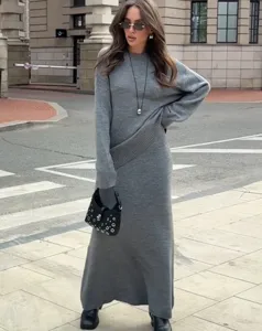 Vue détaillée du pull et de la jupe en tricot gris, affichant une texture douce et confortable.