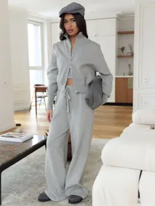 Grey knit zip jacket and wide leg pants set detail view, comfortable lounge wear outfit.