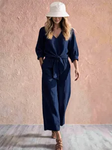 Navy blue v-neck tie-front top detail, casual vacation style three-quarter sleeve outfit.