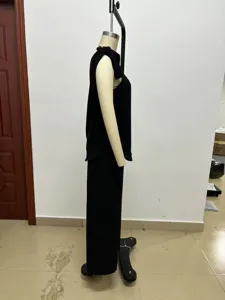 Sleeveless one-shoulder top detail with matching wide-leg pants in solid black color.