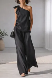 Black one-shoulder sleeveless top featuring elegant tie detail paired with chic wide-leg pants.