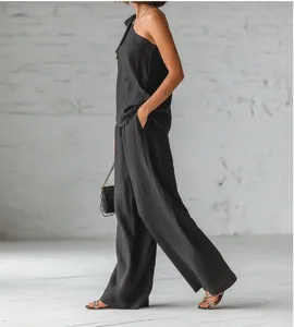 Sleeveless one-shoulder top and wide-leg pants set, stylish spring summer outfit for women.