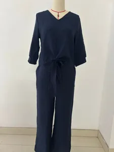 Dark blue V-neck tie-front top and long pants two-piece set, casual holiday style detail shot.