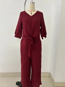 Detail view of the dark red V-neck two-piece set featuring a stylish front knot and sleeves.