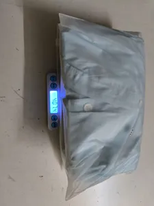Detail shot of packaged women casual set in size XXL on weighing scale, light blue.