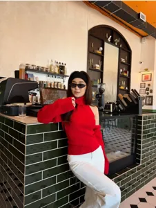 Detail view of red halter knit sweater set, stylish cold shoulder design for women.