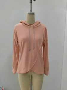 Casual women's pink hoodie with asymmetric hem and sparkly drawstring. Comfortable winter wear.