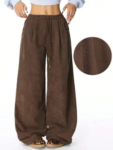 Brown corduroy wide-leg pants featuring a high waist, drawstring, and stylish drape look.