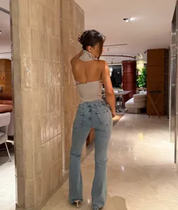 Detailed view of the stylish halter backless knit top and flared jeans fashion set.