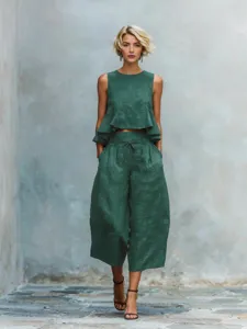 Linen blend two-piece set featuring a sleeveless ruffle crop top and wide-leg pants.