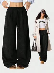 Detailed shot of black corduroy wide leg pants with high waist and adjustable drawstring.
