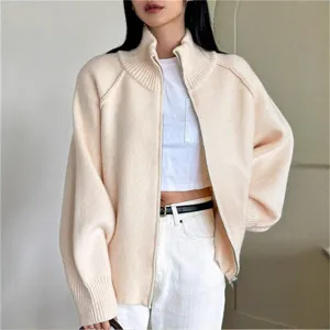 Close-up detail of women's cozy knit zip-up cardigan with ribbed high collar and cuffs.