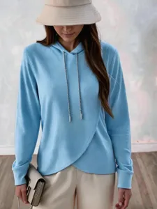 Casual light blue fleece hoodie detail, featuring metallic drawstrings and asymmetric hem.