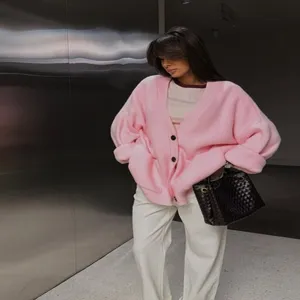 Pink oversized knit cardigan for women, thick V-neck button-up sweater coat detail view.
