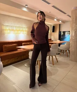 Detailed view of women autumn knitwear set featuring halter cut out top and matching flare pants.