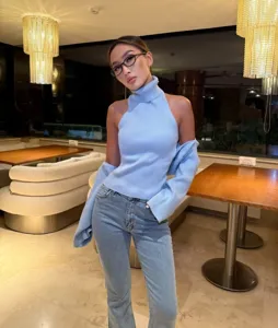 Women autumn knitwear set halter neck sleeveless sweater with matching long sleeve shrug outfit.