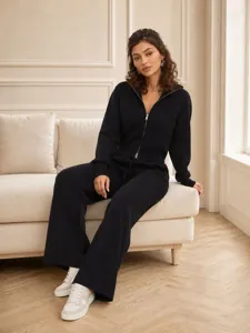 Detailed view of the elegant black knit zip-up hoodie and matching wide-leg pants outfit.