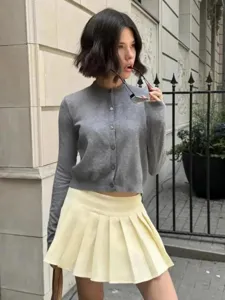 Detailansicht eines grauen Strick-Cardigans mit Knöpfen, klassischem Rundhalsausschnitt und Passform.