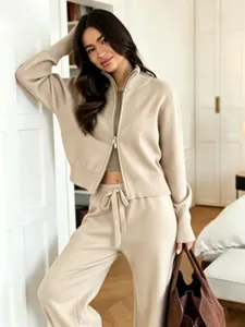 Elegant beige knit zip-up cardigan and matching wide-leg trousers two-piece suit.