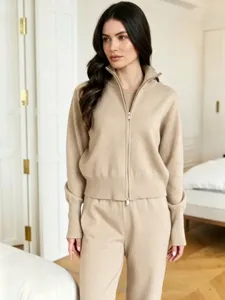Detail view of the elegant beige knit zip-up cardigan and lounge pants set for women.