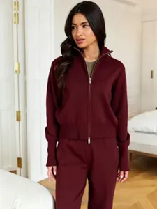 Detailed view of women's burgundy zip sweater and pants set, elegant autumn casual outfit detail.