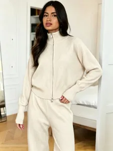 Close-up detail of the beige knitted zip-up cardigan and matching lounge pants set.