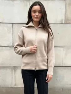 Close-up view of the beige knit zip cardigan showcasing ribbed texture and collar detail.