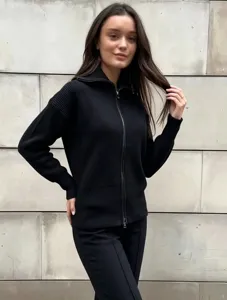 Women black ribbed knit zip cardigan sweater detail view, stylish casual outerwear.