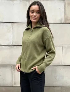 Close-up of olive green knitted zip-up cardigan showing ribbed texture and collar.