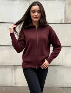 Detailed close-up of a stylish burgundy zip-up knit cardigan sweater showing ribbed texture.