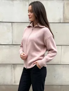 Women's stylish knitted zip up cardigan sweater detail, cozy pink ribbed fabric design.