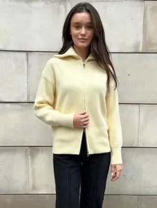 Women's light yellow ribbed knit zip-up cardigan sweater detail view, cozy daily wear.