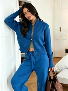 Blue knit zip-up cardigan and matching pants set detail view for women lifestyle.